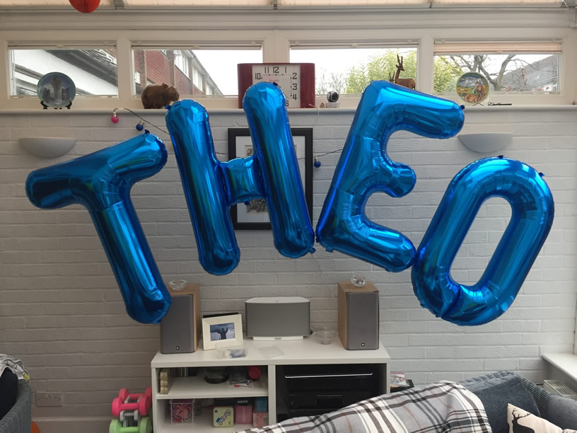 Foil Balloon Arch with letters spelling Theo