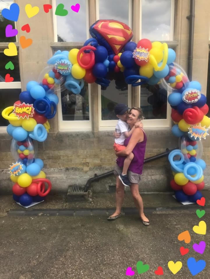 Super Hero balloon arch with Julie and Spencer